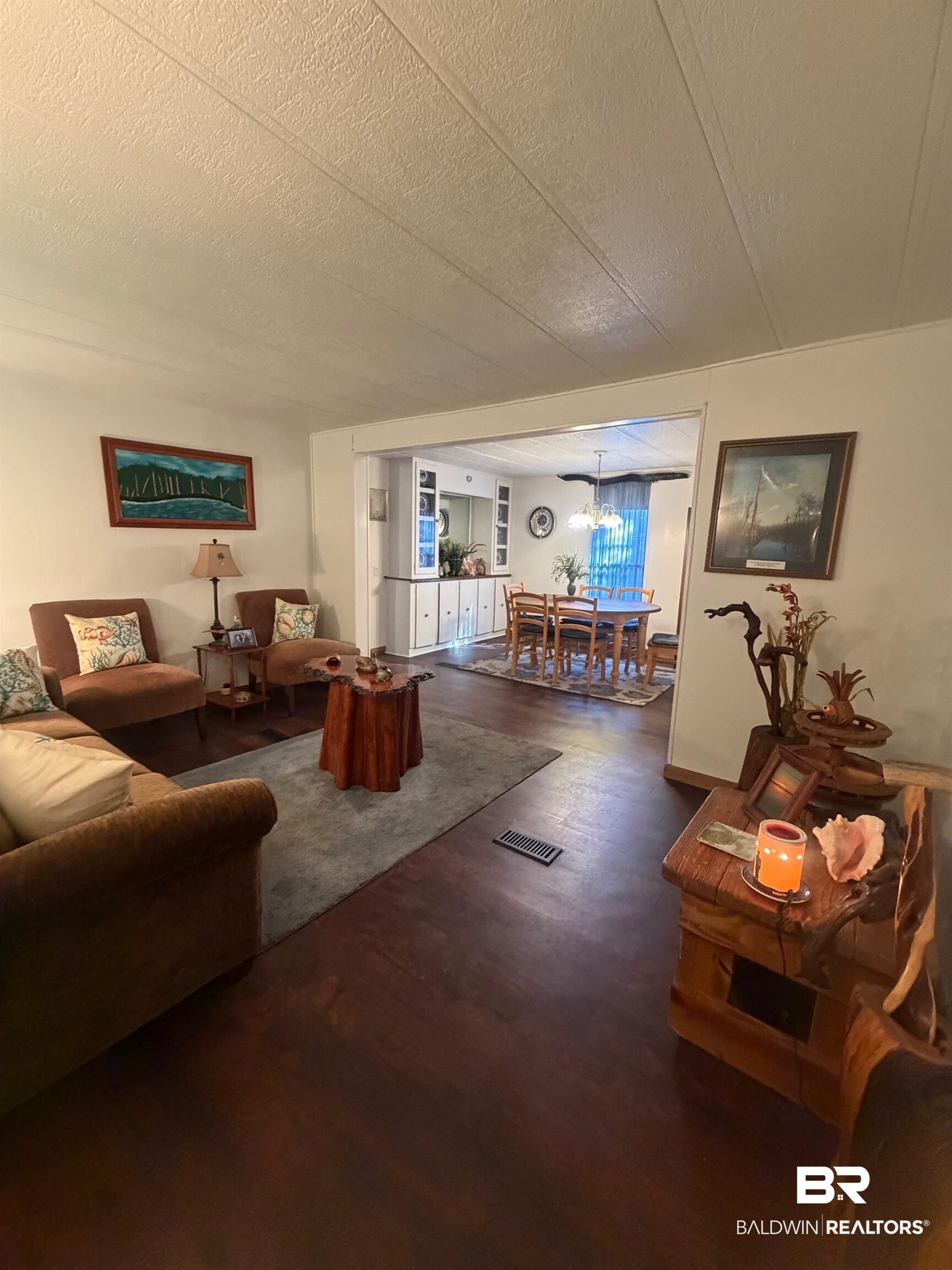 1430 Ridgewood Drive Lillian, AL 36549 - Photo 4 of 34 Living area featuring dark wood finished floors and a textured ceiling