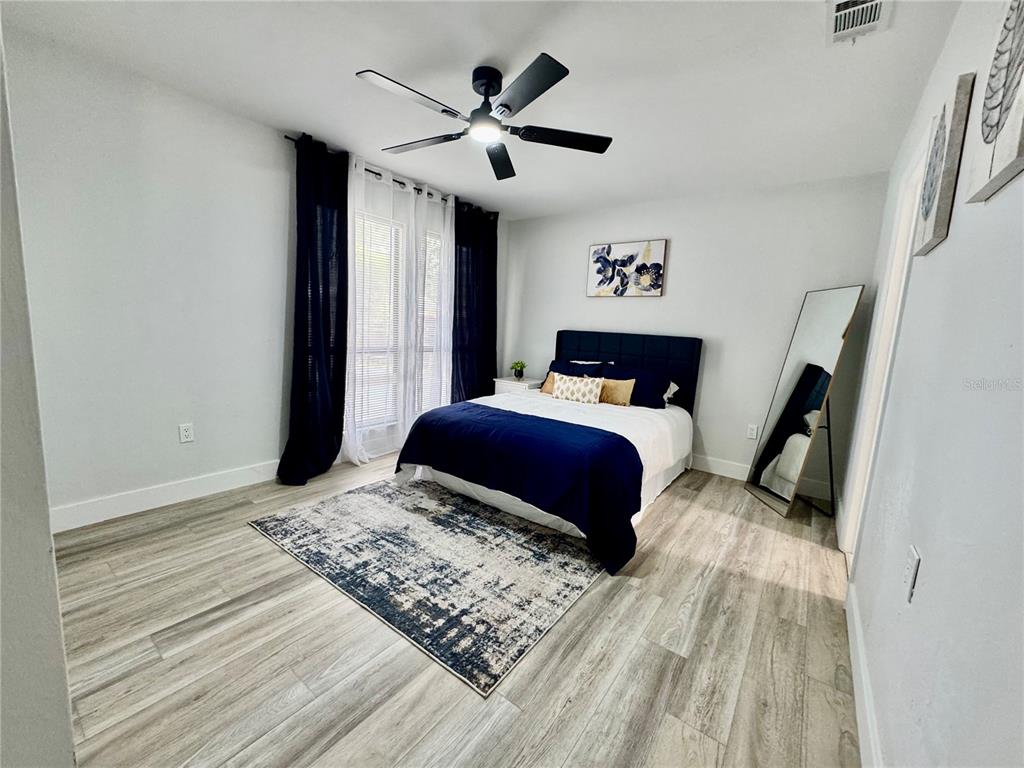 5407 Southwest 82 Terrace Gainesville, FL 32608 - Photo 20 of 31 a bedroom with a bed and a chandelier
