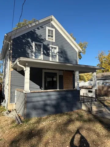 a view of a house with backyard porch and sitting area