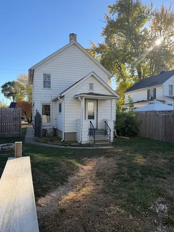 a front view of a house with a yard and porch