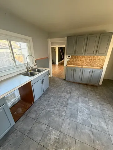 a kitchen with a sink a stove a microwave and cabinets