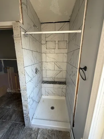 a bathroom with a glass shower door
