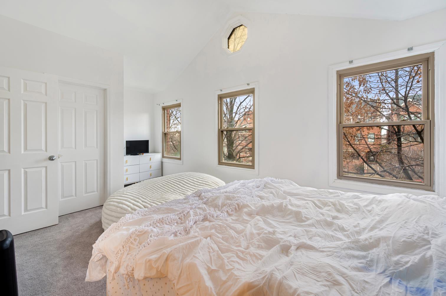 1319 West 32nd Place Chicago, IL 60608 - Photo 21 of 46 a bedroom with a large bed and a window