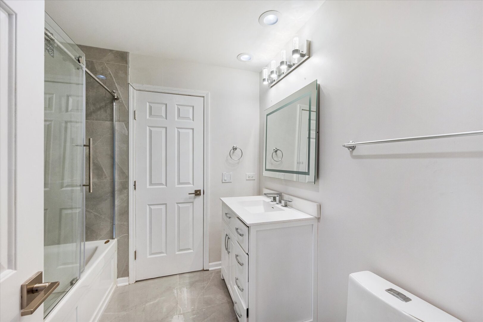 1319 West 32nd Place Chicago, IL 60608 - Photo 22 of 46 a spacious bathroom with a double vanity sink a mirror and a bathtub