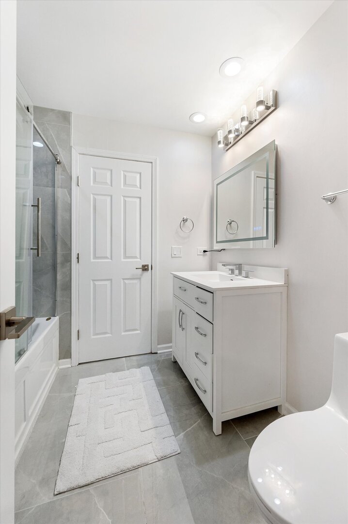 1319 West 32nd Place Chicago, IL 60608 - Photo 23 of 46 a bathroom with a sink a toilet and shower