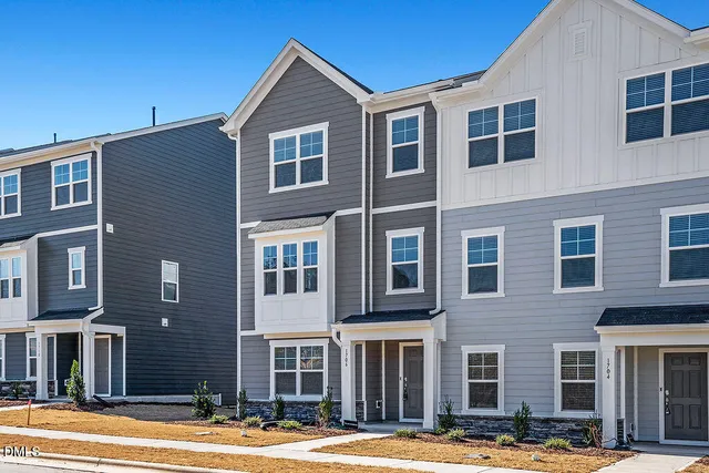 a front view of residential houses with yard