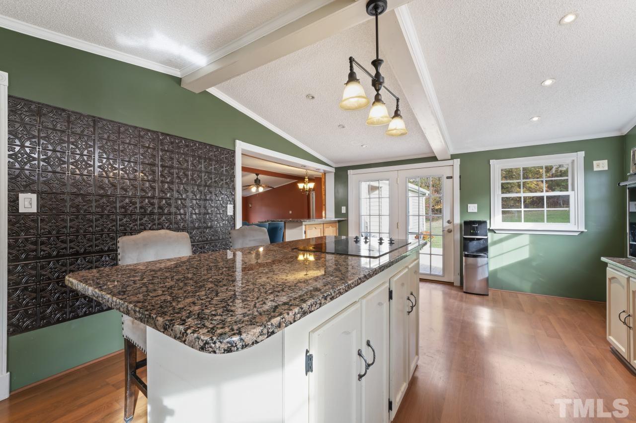 1231 Stoney Mountain Road Rougemont, NC 27572 - Photo 19 of 45 a kitchen with stainless steel appliances granite countertop a sink a stove and a microwave