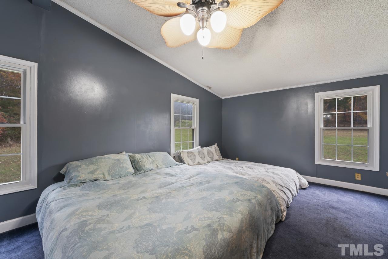 1231 Stoney Mountain Road Rougemont, NC 27572 - Photo 25 of 45 a bedroom with a large bed and a window