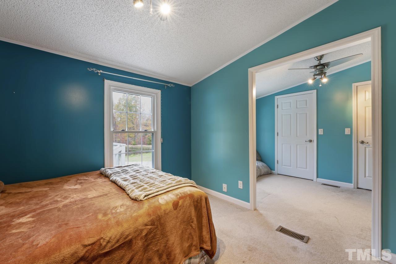 1231 Stoney Mountain Road Rougemont, NC 27572 - Photo 33 of 45 a bedroom with a bed and a window