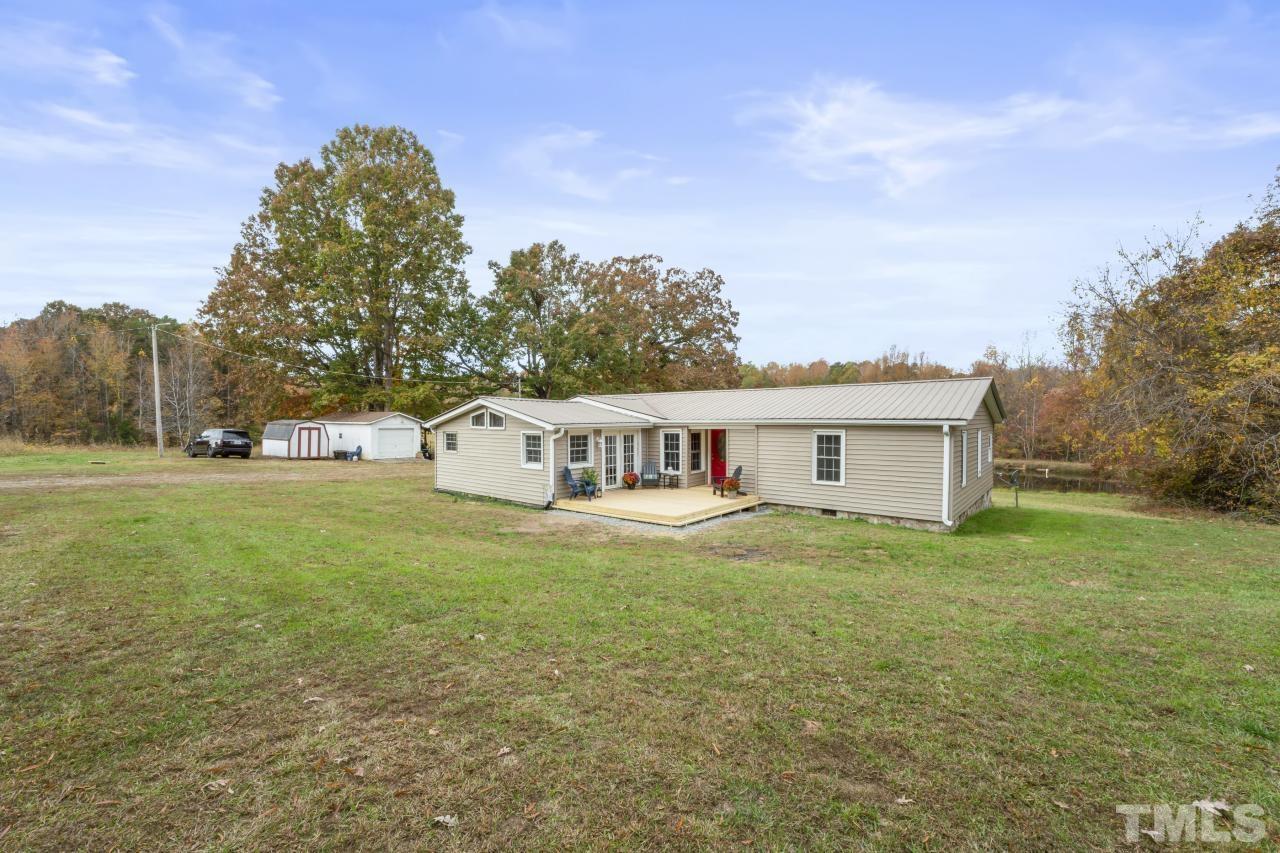 1231 Stoney Mountain Road Rougemont, NC 27572 - Photo 37 of 45 a house that is sitting in the grass with large trees