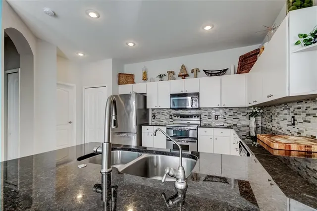 a kitchen with cabinets and window