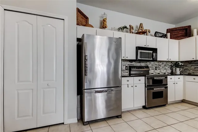 a bathroom with a double vanity sink mirror and shower
