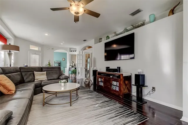 a living room with furniture and a book shelf