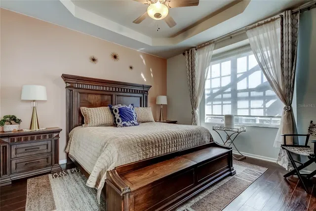 a living room with furniture a piano and a bookshelf