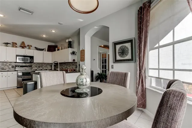 a kitchen with granite countertop a stove sink and microwave