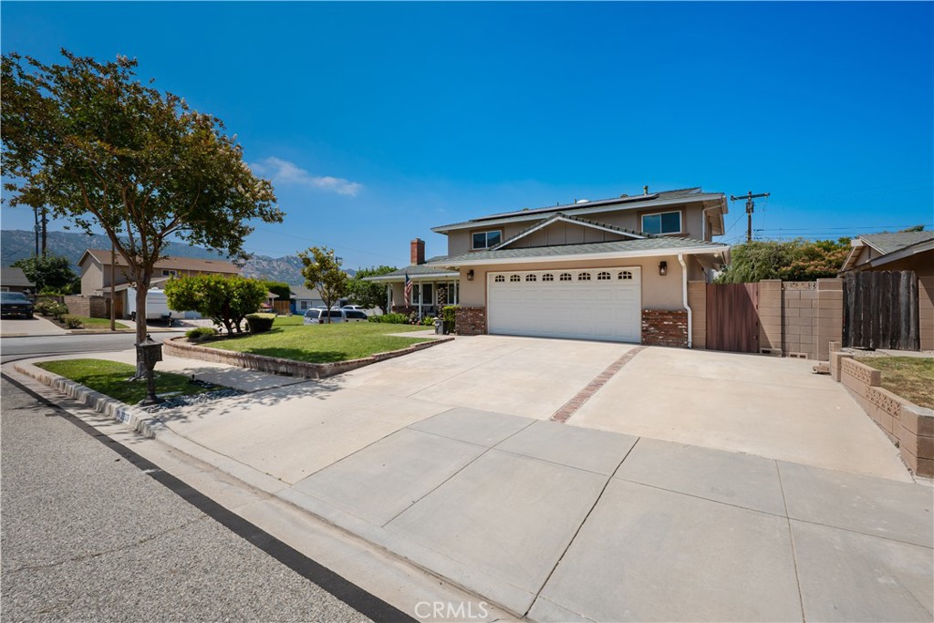 2203 Homewood Avenue Simi Valley, CA 93063 - Photo 37 of 37 a front view of a house with a yard and potted plants