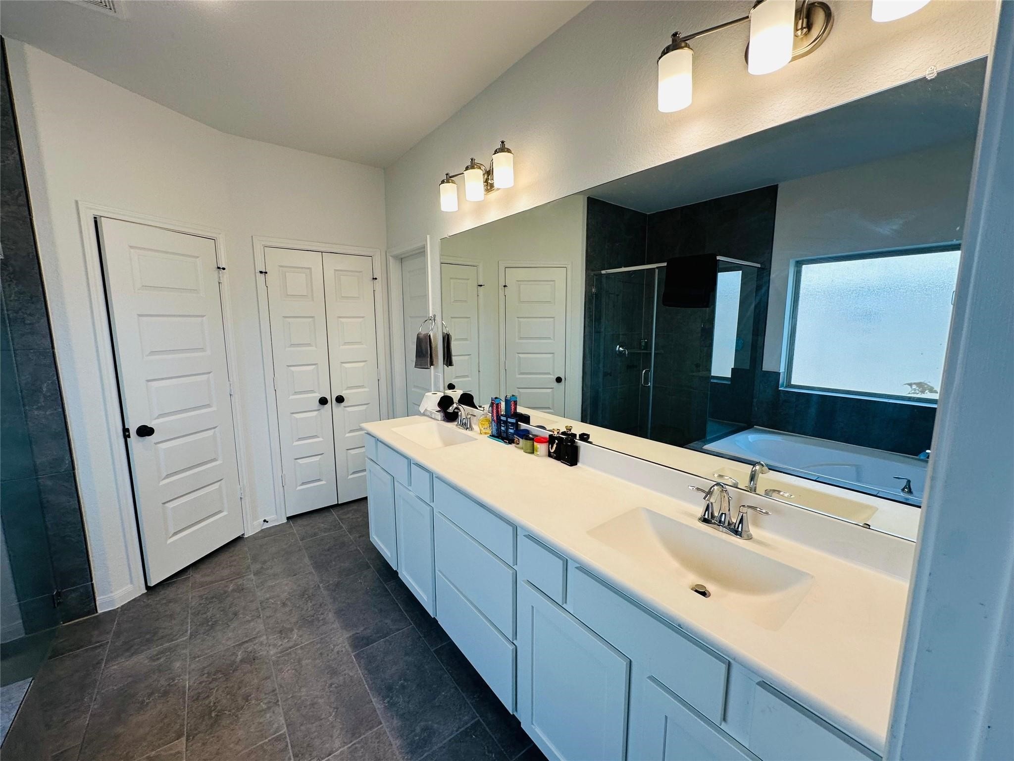 2419 Humble Way Rosenberg, TX 77471 - Photo 12 of 38 a bathroom with a double vanity sink and mirror