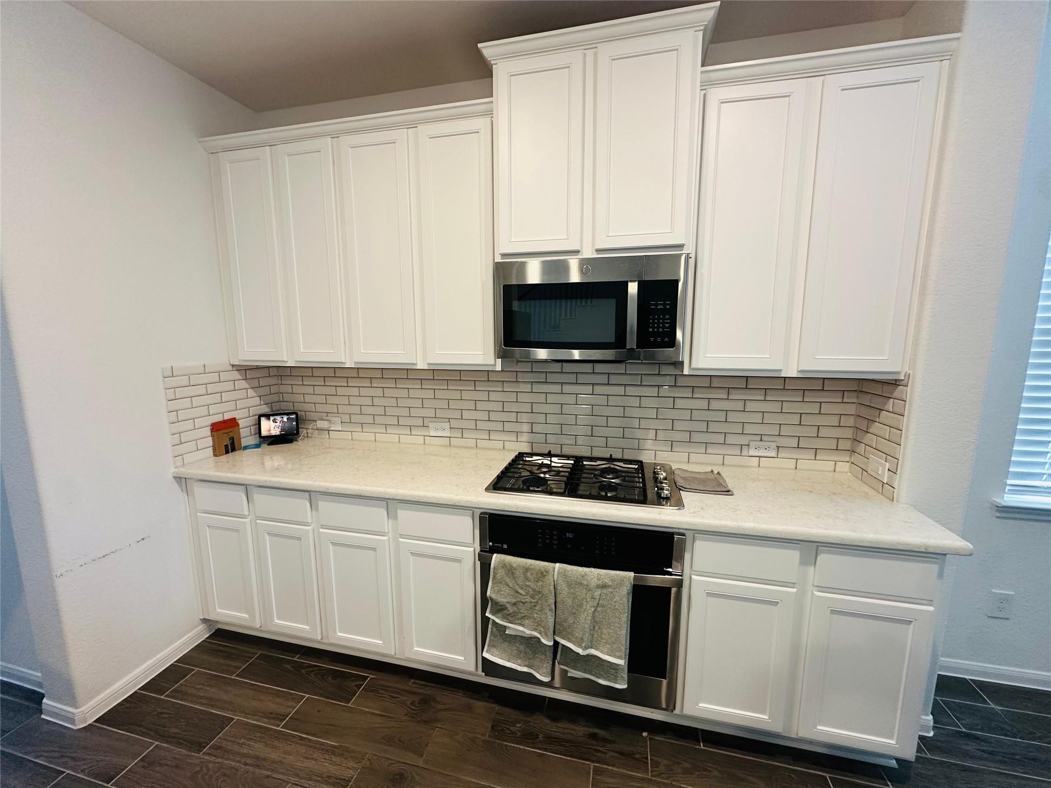 2419 Humble Way Rosenberg, TX 77471 - Photo 33 of 38 a kitchen with appliances a sink and cabinets