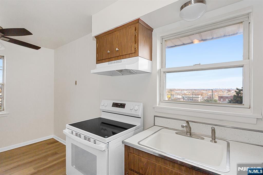 145 Arnot Street, Unit 4B Lodi, NJ 07644 - Photo 11 of 21 a kitchen with a stove and a sink