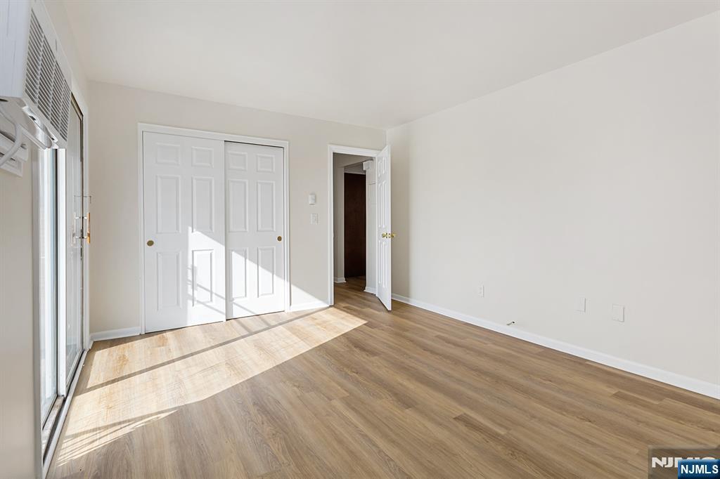 145 Arnot Street, Unit 4B Lodi, NJ 07644 - Photo 15 of 21 a view of an empty room with wooden floor