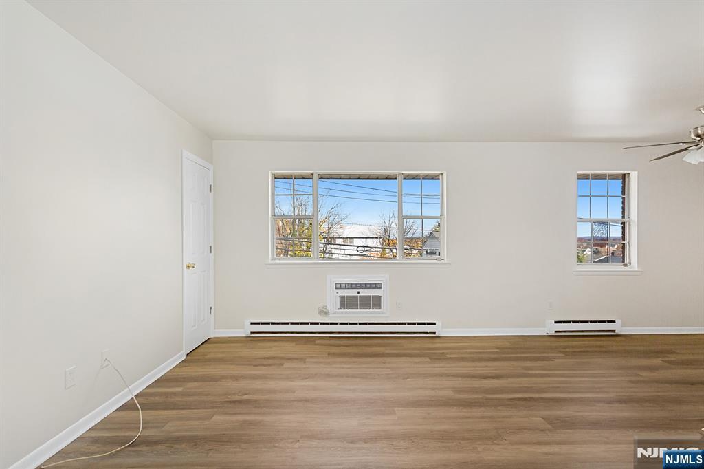 145 Arnot Street, Unit 4B Lodi, NJ 07644 - Photo 4 of 21 a view of empty room with wooden floor
