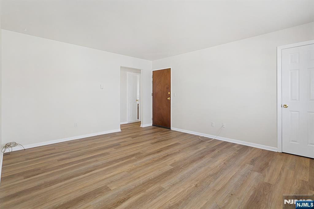 145 Arnot Street, Unit 4B Lodi, NJ 07644 - Photo 6 of 21 a view of an empty room with wooden floor