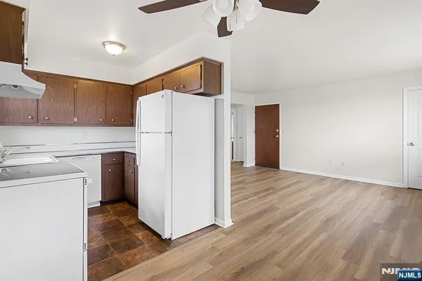 a kitchen with a refrigerator a microwave and cabinets