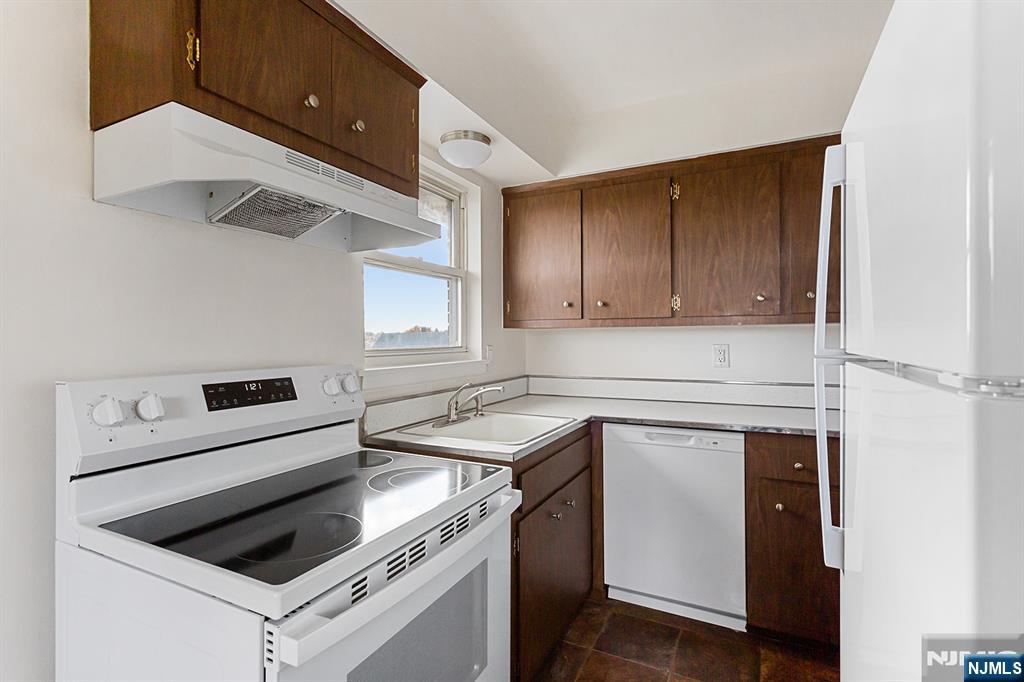 145 Arnot Street, Unit 4B Lodi, NJ 07644 - Photo 9 of 21 a kitchen with a stove cabinets and a refrigerator