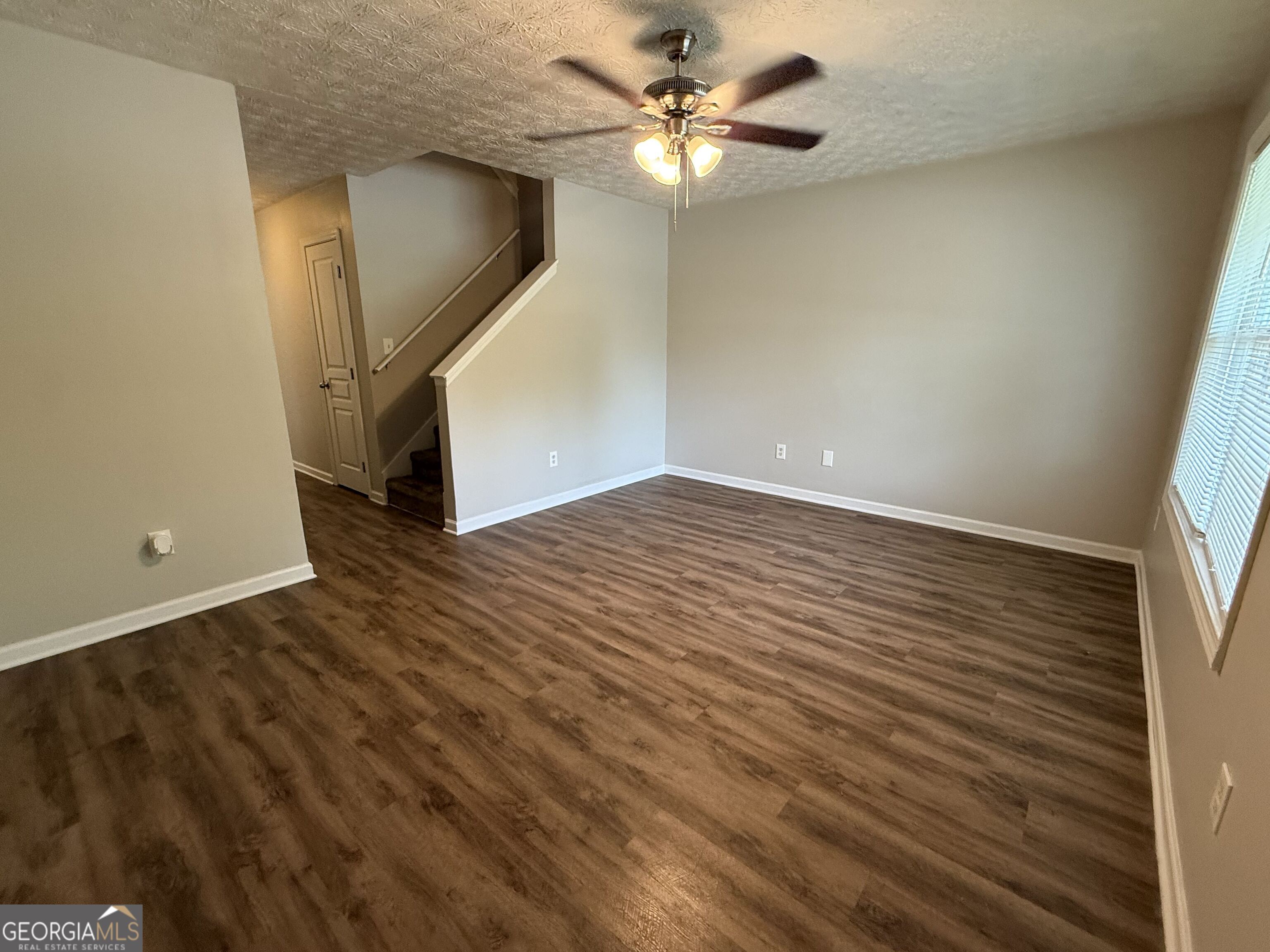 6132 Ruth Street Southwest Covington, GA 30014 - Photo 6 of 33 wooden floor in an empty room with a window