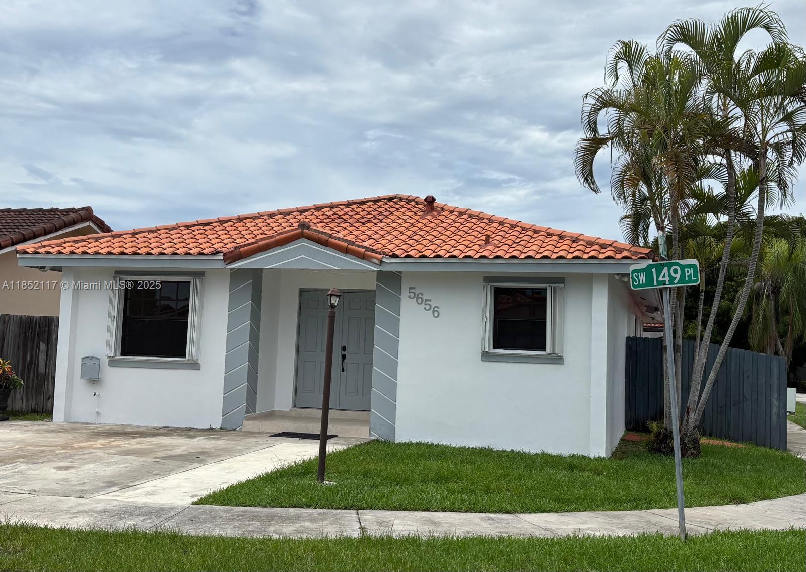 5656 Southwest 149th Place Miami, FL 33193 - Photo 1 of 28 a front view of a house with a garden and plants