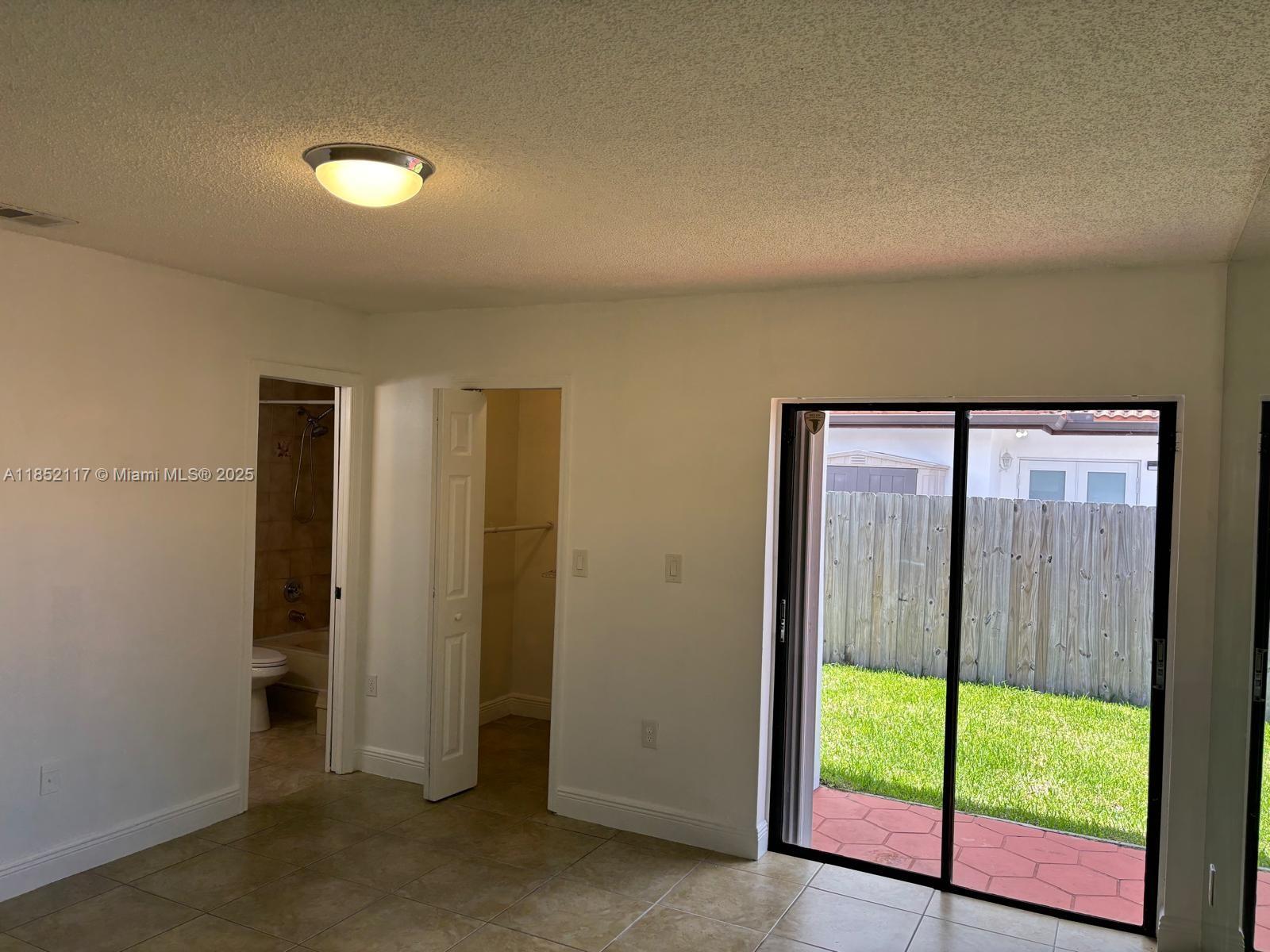 5656 Southwest 149th Place Miami, FL 33193 - Photo 19 of 28 a view of an empty room with wooden floor and a window