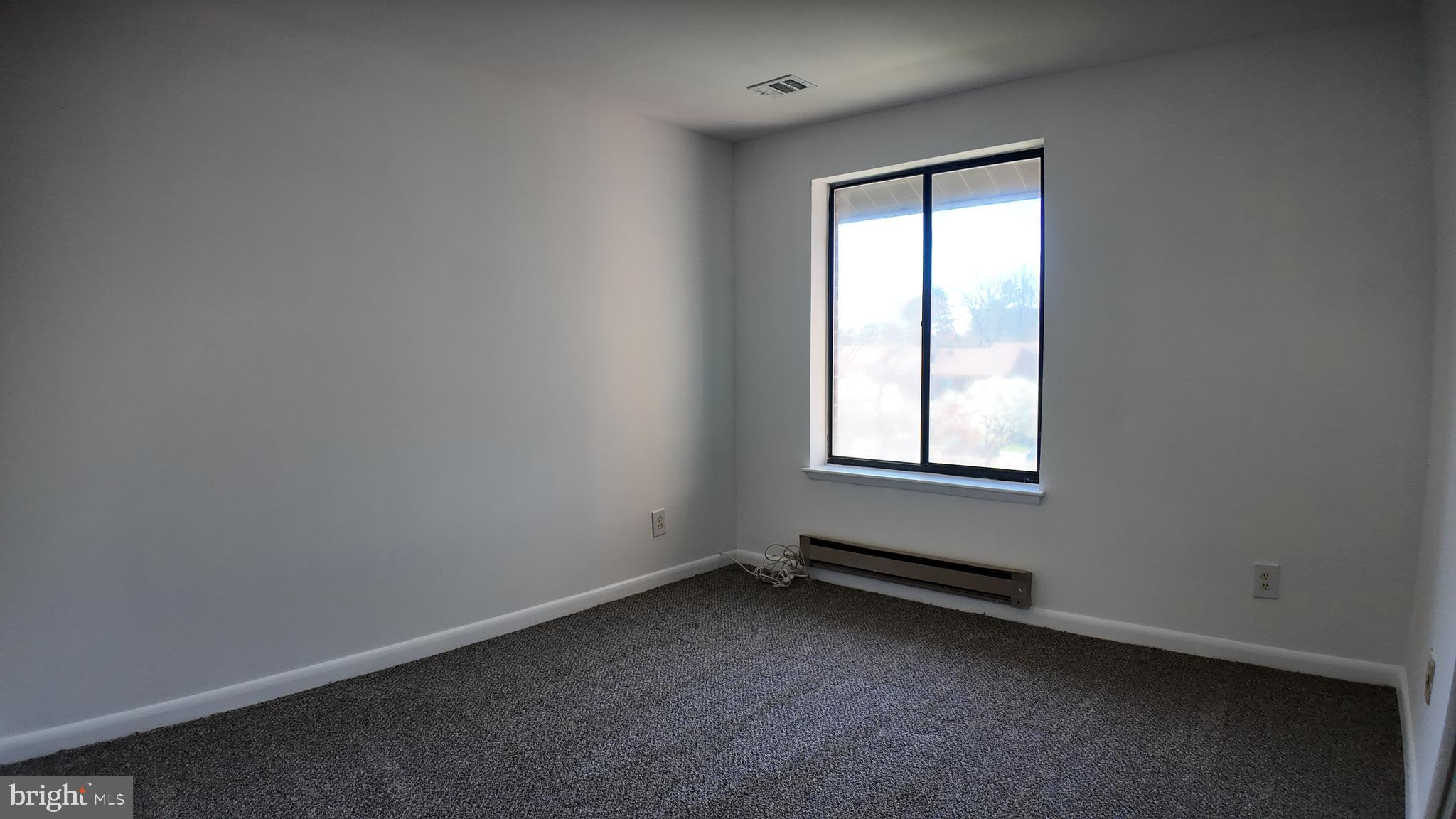 15311 Beaverbrook Court, Unit 903B Silver Spring, MD 20906 - Photo 20 of 36 an empty room with a window