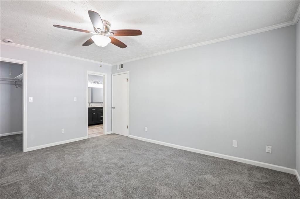6430 Oakleaf Way Morrow, GA 30260 - Photo 11 of 23 an empty room with closet and ceiling fan