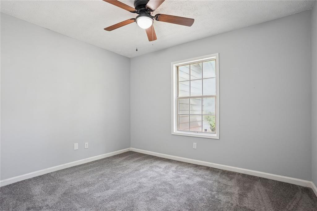 6430 Oakleaf Way Morrow, GA 30260 - Photo 13 of 23 an empty room with a window and a fan