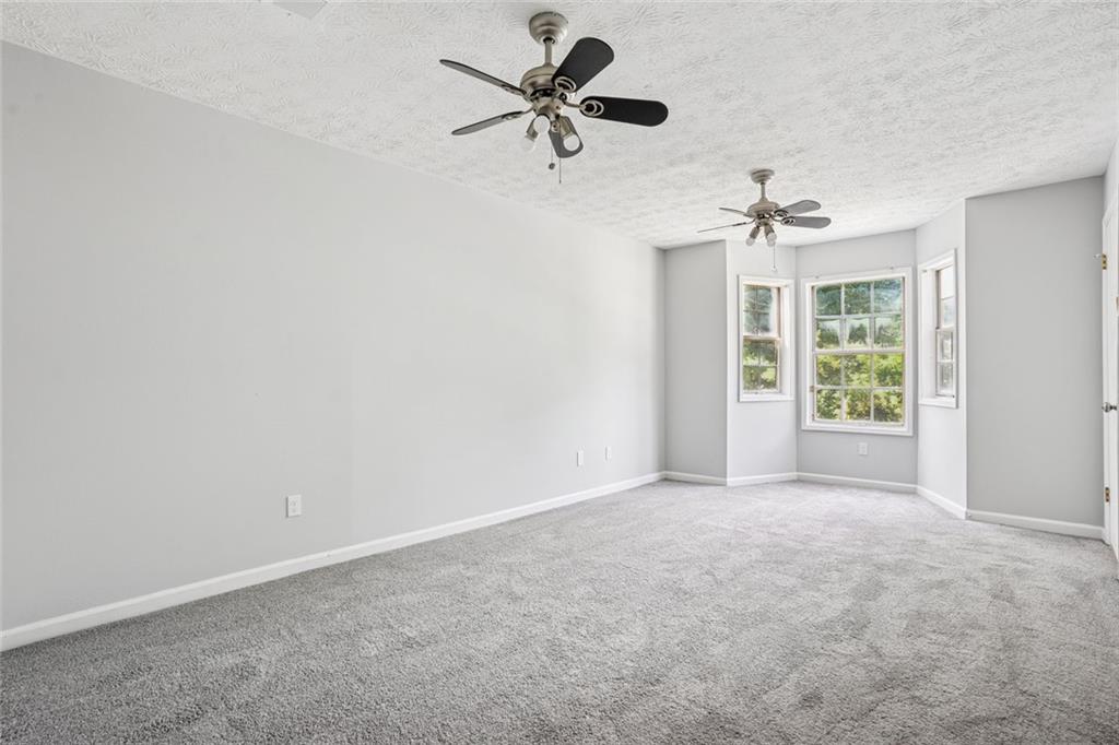 6430 Oakleaf Way Morrow, GA 30260 - Photo 19 of 23 a view of a room with a ceiling fan and a window
