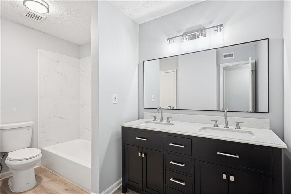 6430 Oakleaf Way Morrow, GA 30260 - Photo 4 of 23 a bathroom with a double vanity sink and a mirror