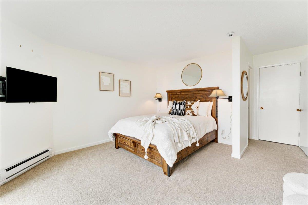 101 Shell Road, Unit 62 Watsonville, CA 95076 - Photo 14 of 38 a spacious bedroom with a bed and a flat screen tv