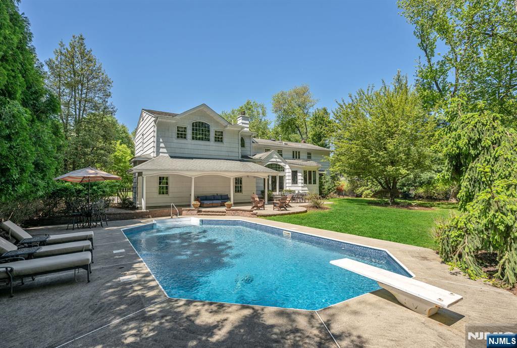 411 Snyder Road Wyckoff, NJ 07481 - Photo 2 of 36 a view of a house with swimming pool and sitting area