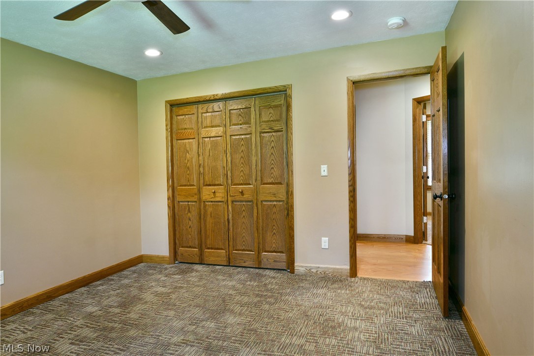 754 Warner Road Hubbard, OH 44425 - Photo 37 of 46 Interior room featuring textured carpeting, neutral wall tones, and wood-finish trim