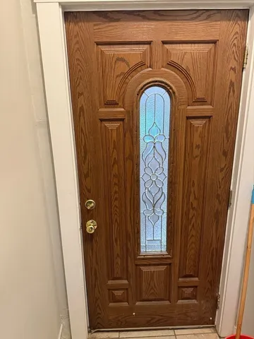 a view of front door with wooden door