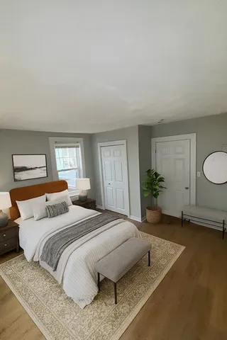 a bedroom with a bed and window