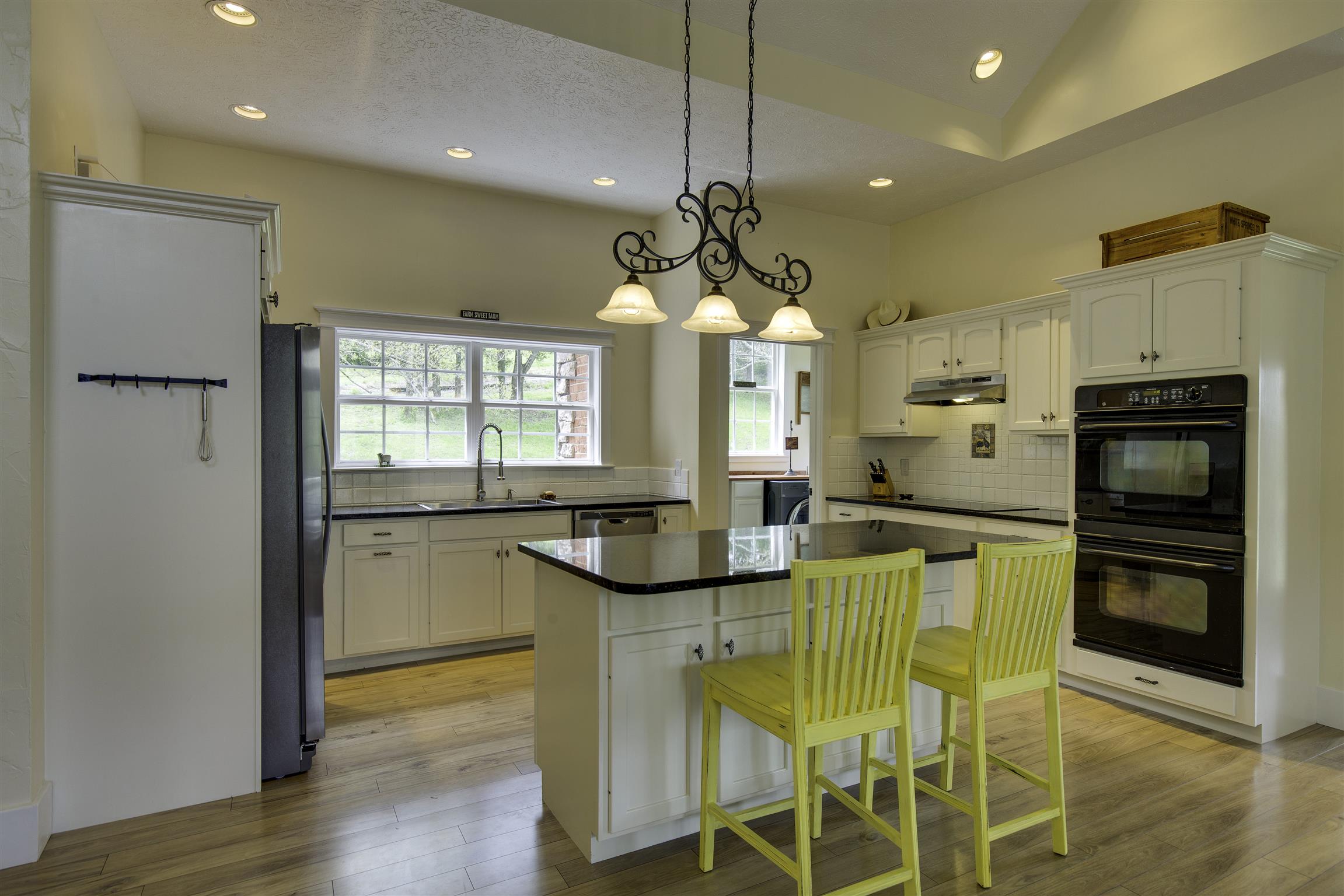 685 Bates Road Lebanon, TN 37087 - Photo 8 of 30 a kitchen with stainless steel appliances kitchen island granite countertop a refrigerator a stove a microwave oven a sink with island and chairs