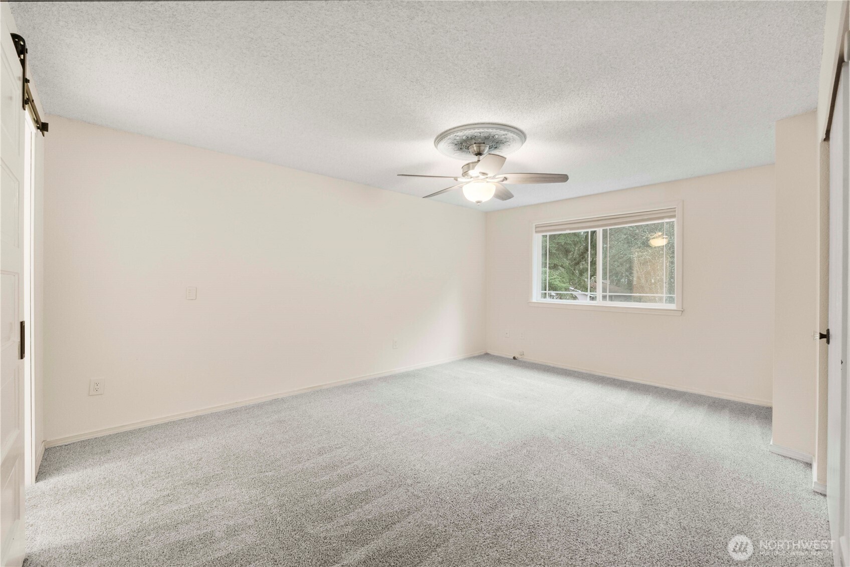 832 Torrey Street Southeast Olympia, WA 98513 - Photo 13 of 27 an empty room with a chandelier fan and windows