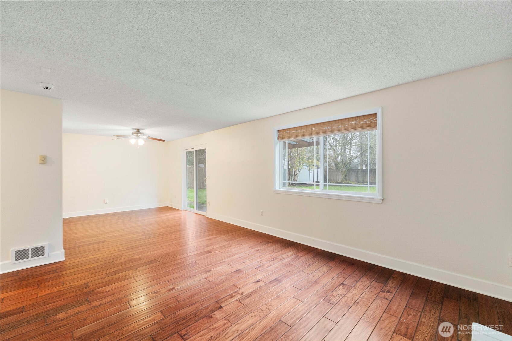 832 Torrey Street Southeast Olympia, WA 98513 - Photo 9 of 27 a view of an empty room with wooden floor and a window