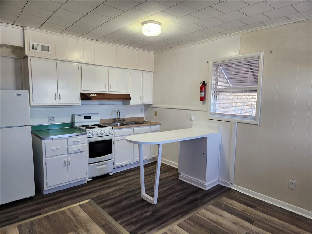 120 East 1st Avenue, Unit 201 Derry, PA 15627 - Photo 2 of 5 a kitchen with granite countertop a sink cabinets stainless steel appliances and a counter top space