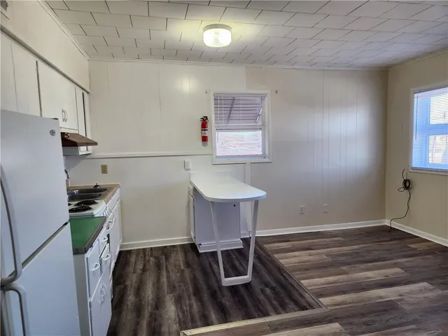 a room with wooden floor and window