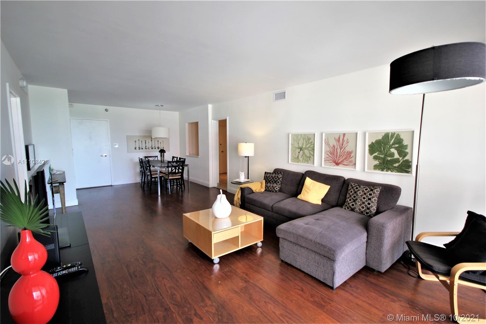 5161 Collins Avenue, Unit 711 Miami Beach, FL 33140 - Photo 2 of 67 a living room with furniture and wooden floor