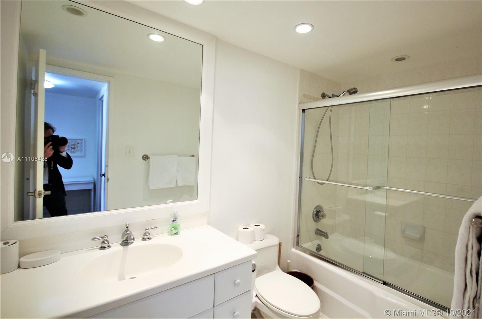 5161 Collins Avenue, Unit 711 Miami Beach, FL 33140 - Photo 15 of 67 a bathroom with a granite countertop sink toilet and shower