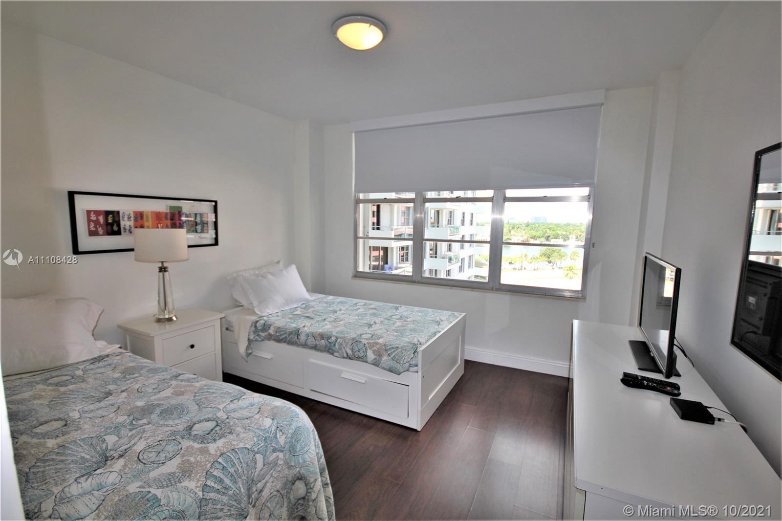 5161 Collins Avenue, Unit 711 Miami Beach, FL 33140 - Photo 18 of 67 a bedroom with a bed and a window