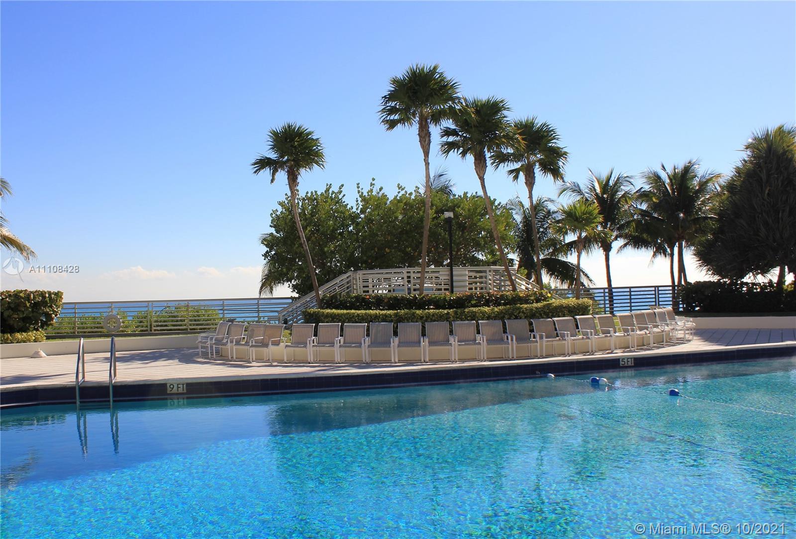 5161 Collins Avenue, Unit 711 Miami Beach, FL 33140 - Photo 27 of 67 a view of a swimming pool with a yard